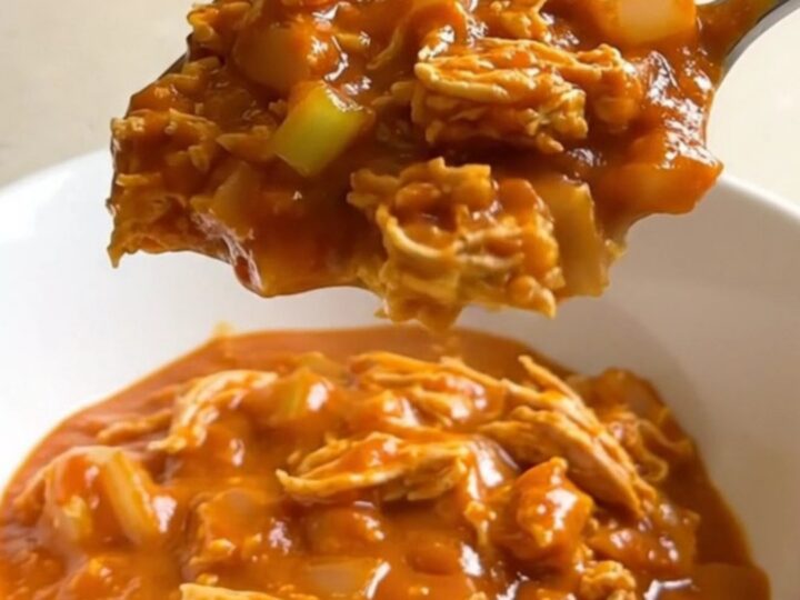 A white shallow bowl filled with Slow Cooker Buffalo Turkey Sloppy Joes, showing turkey, celery