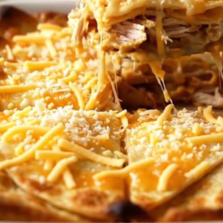 A golden-brown chicken quesadilla bake in a white ceramic dish.