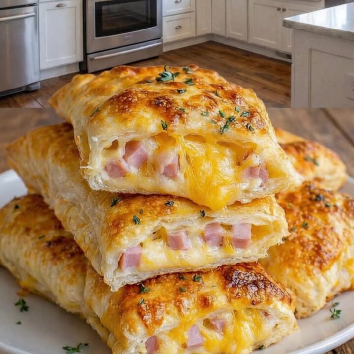 A stack of golden, crispy ham and cheese pockets on a white plate over a wooden surface.