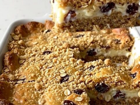 A top-down view of a rectangular baking dish filled with golden brown oat bars.