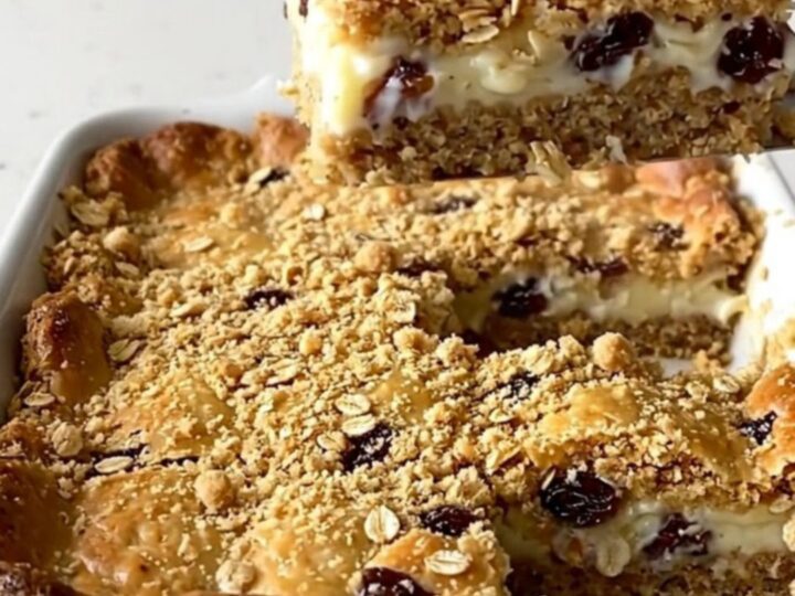 A top-down view of a rectangular baking dish filled with golden brown oat bars.