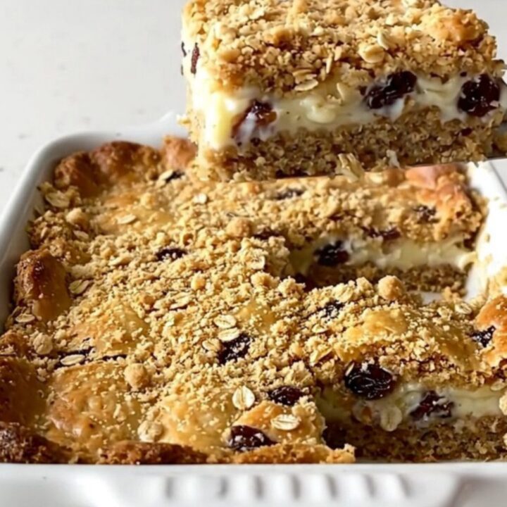 A top-down view of a rectangular baking dish filled with golden brown oat bars.