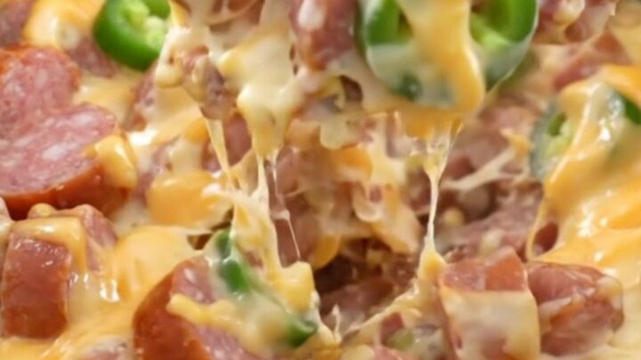A close-up of creamy jalapeno popper sausage and potatoes in a slow cooker.