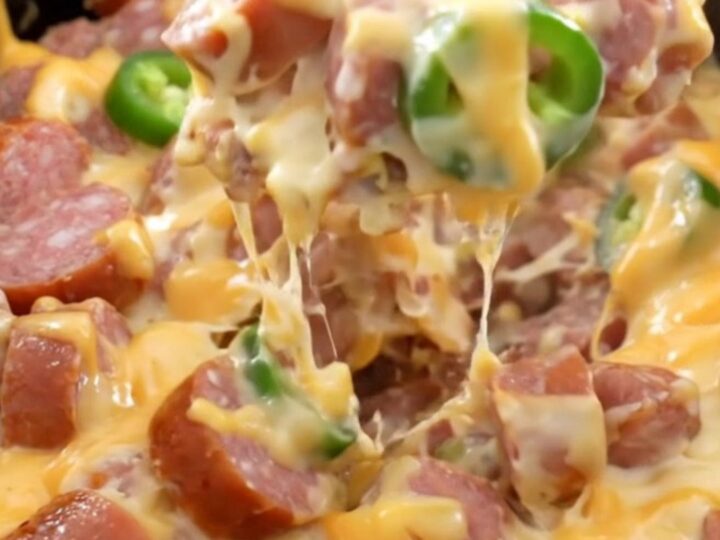 A close-up of creamy jalapeno popper sausage and potatoes in a slow cooker.