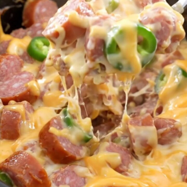 A close-up of creamy jalapeno popper sausage and potatoes in a slow cooker.