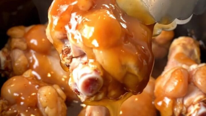 A plate of slow-cooked spicy honey barbecue chicken wings with a glossy finish.