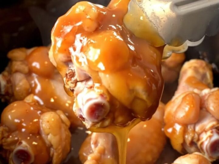 A plate of slow-cooked spicy honey barbecue chicken wings with a glossy finish.