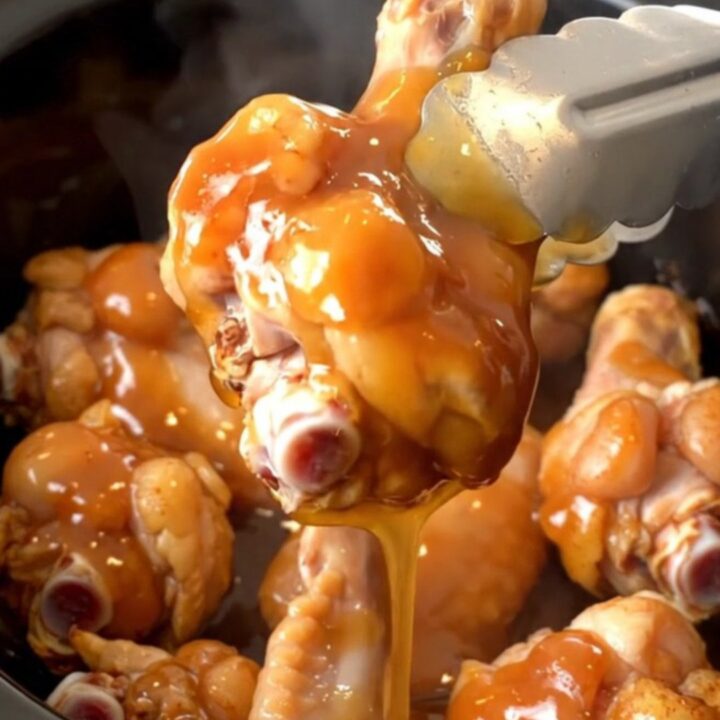 A plate of slow-cooked spicy honey barbecue chicken wings with a glossy finish.