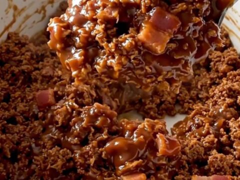 A close-up of a serving of BBQ bacon turkey sloppy joe mixture in a white ceramic bowl.