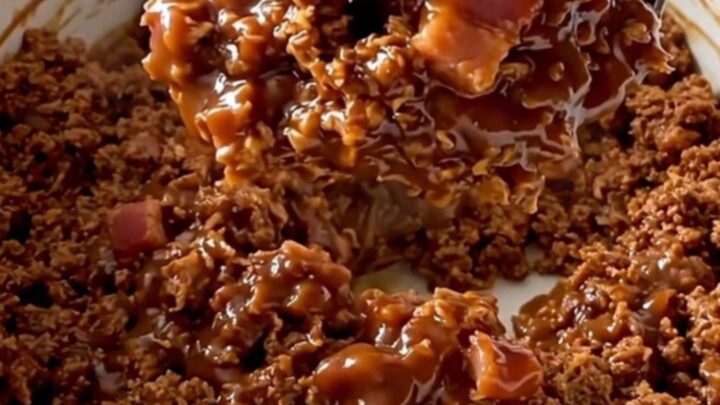 A close-up of a serving of BBQ bacon turkey sloppy joe mixture in a white ceramic bowl.