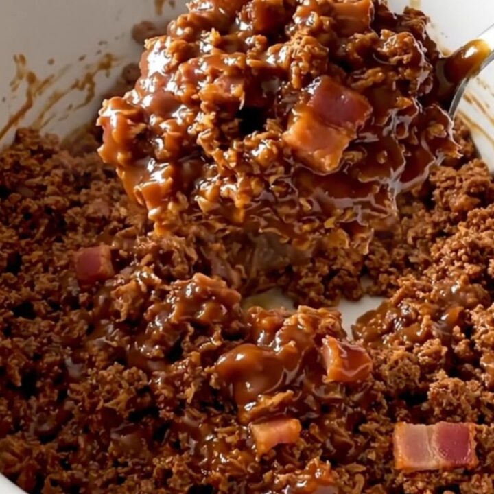 A close-up of a serving of BBQ bacon turkey sloppy joe mixture in a white ceramic bowl.
