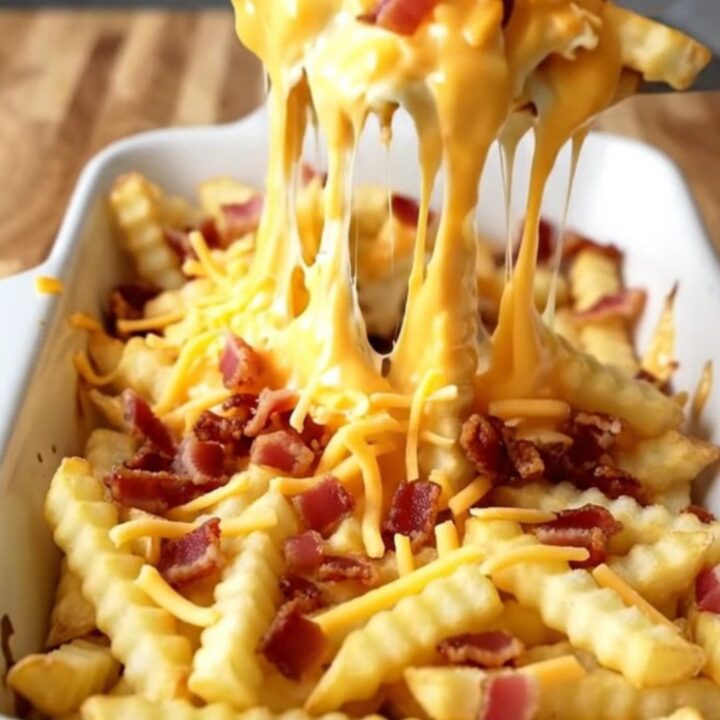 A top-down view of a rectangular baking dish filled with golden baked fries