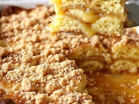A top-down view of a golden brown breakfast casserole in a white dish, topped with cinnamon streusel.