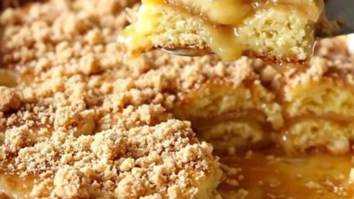 A top-down view of a golden brown breakfast casserole in a white dish, topped with cinnamon streusel.