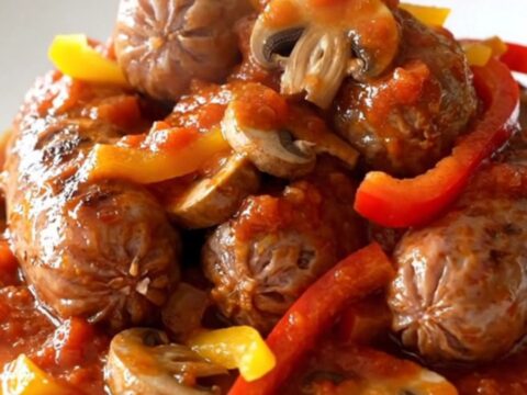Slow cooker Italian sausage cacciatore with bell peppers and mushrooms in a rich tomato sauce.