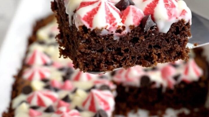 A top-down view of Peppermint Bark Magic Bars in a white ceramic baking dish on a speckled quartz counter.