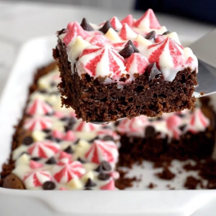 A top-down view of Peppermint Bark Magic Bars in a white ceramic baking dish on a speckled quartz counter.