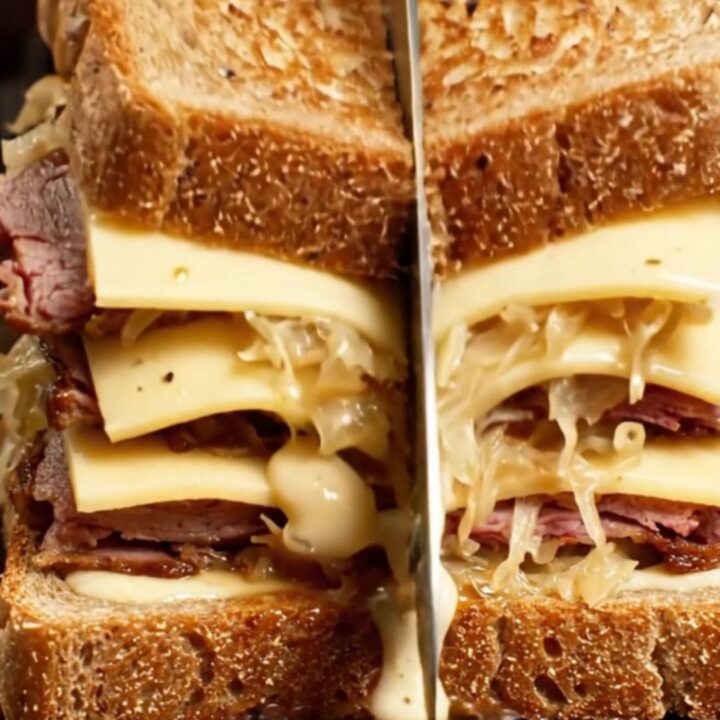 A sky-high pastrami Reuben melt on toasted marble rye with oozing melted Swiss cheese and Russian dressing.