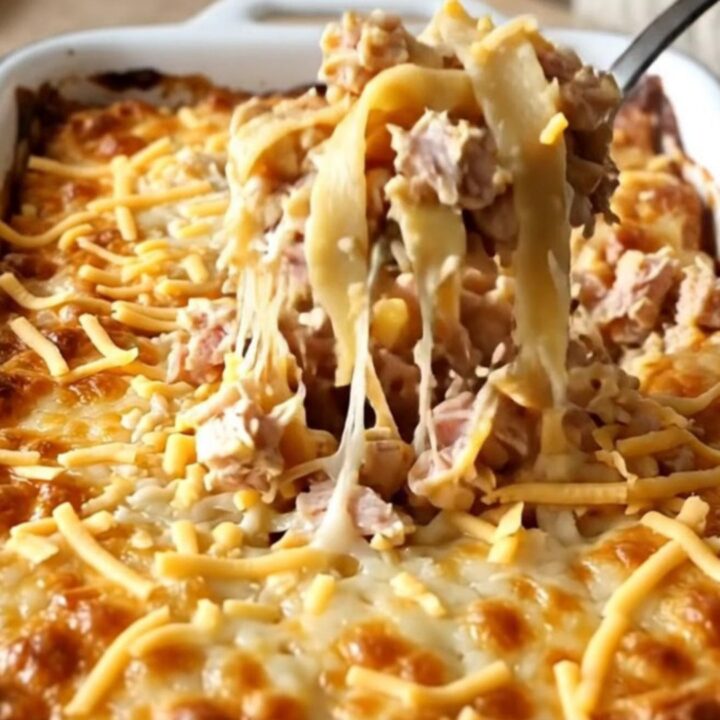 A rectangular baker filled with a golden, cheesy baked noodle and ground turkey dish.