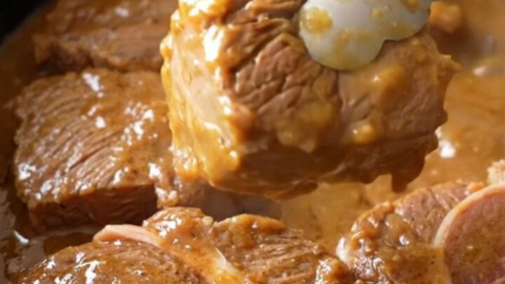 Slow cooker filled with tender beef cube steaks, pepperoncini, and a rich, buttery gravy.