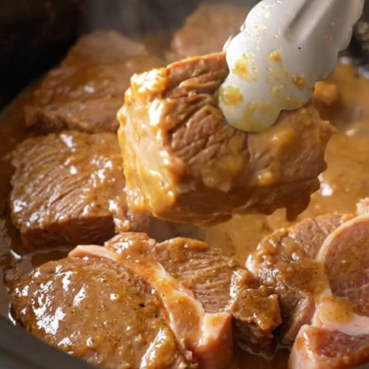 Slow cooker filled with tender beef cube steaks, pepperoncini, and a rich, buttery gravy.