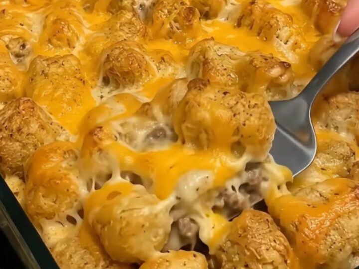 A golden, bubbling tater tot casserole in a baking dish, fresh from the oven.
