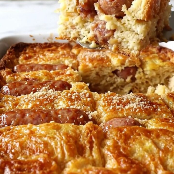 A golden-brown maple sausage French toast bake in a rectangular ceramic dish.
