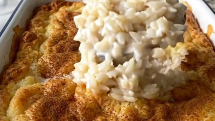 A large rectangular baker filled with creamy baked rice pudding