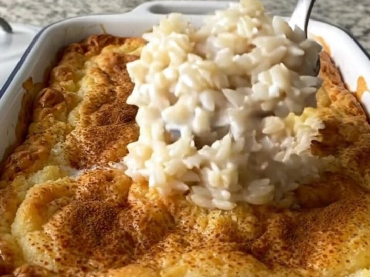 A large rectangular baker filled with creamy baked rice pudding