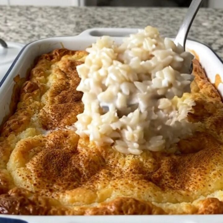 A large rectangular baker filled with creamy baked rice pudding