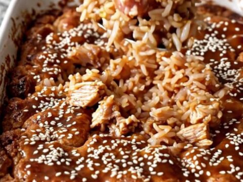 A top-down view of a rectangular ceramic dish filled with cooked teriyaki ground turkey, rice, and broccoli.