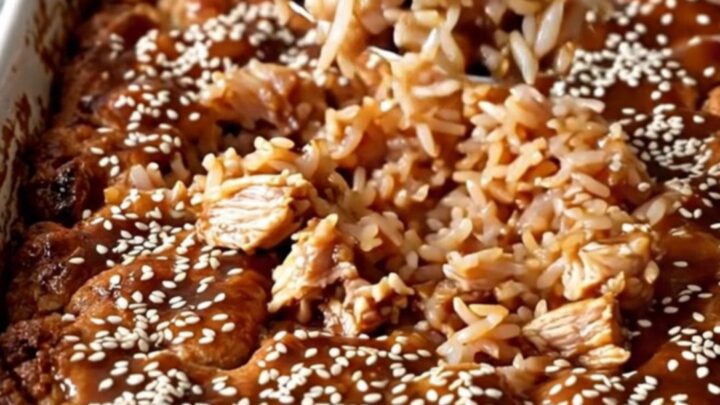 A top-down view of a rectangular ceramic dish filled with cooked teriyaki ground turkey, rice, and broccoli.