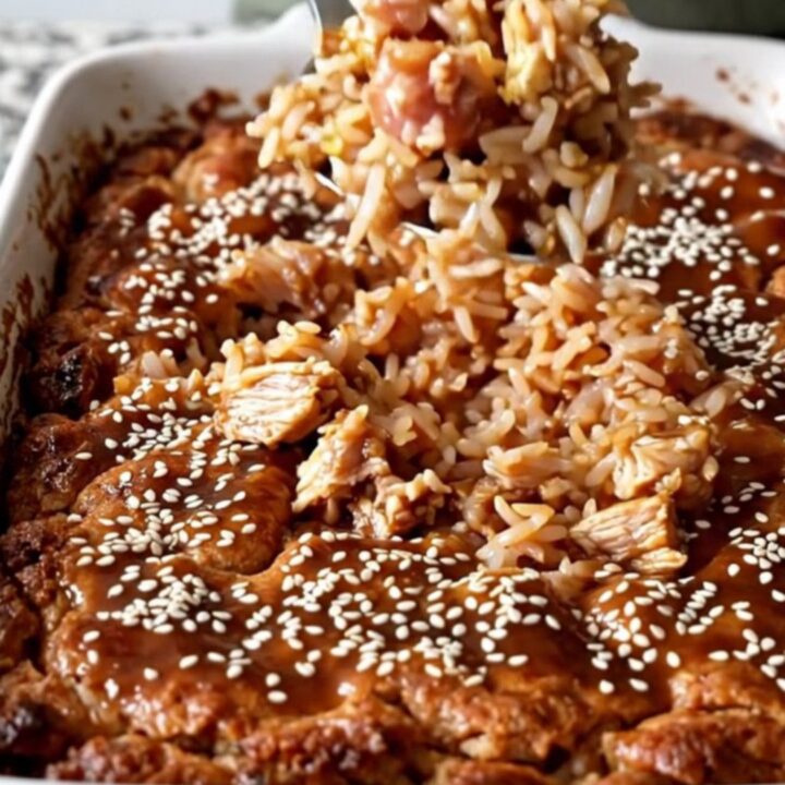 A top-down view of a rectangular ceramic dish filled with cooked teriyaki ground turkey, rice, and broccoli.