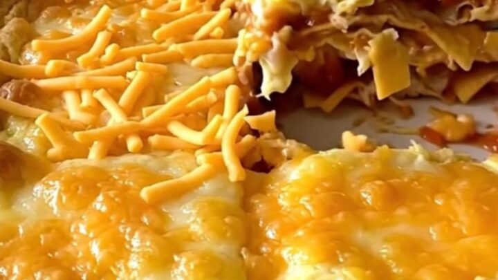 A golden, puffed Tex-Mex migas egg bake in a white ceramic dish.