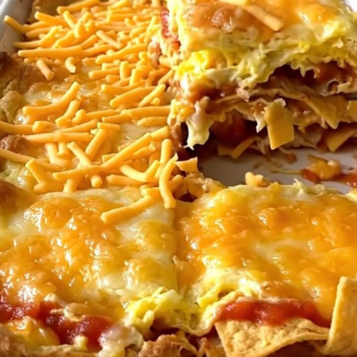 A golden, puffed Tex-Mex migas egg bake in a white ceramic dish.