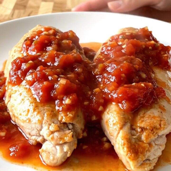 Slow cooker salsa chicken with zucchini and corn served on a white plate.