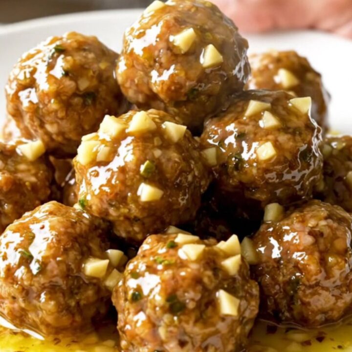 A slow cooker filled with turkey meatballs and gold potatoes coated in a rich, buttery herb sauce.