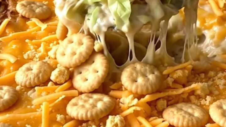 A top-down view of a rectangular baking dish filled with a creamy cabbage casserole topped with golden cracker crumbs.