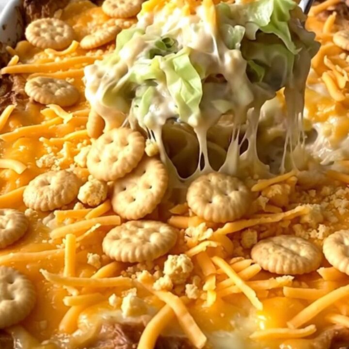A top-down view of a rectangular baking dish filled with a creamy cabbage casserole topped with golden cracker crumbs.