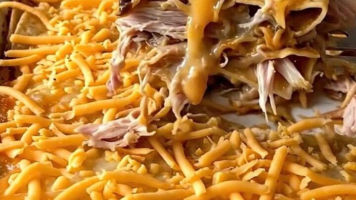 A golden, bubbling King Ranch casserole in a white rectangular dish on a granite countertop.
