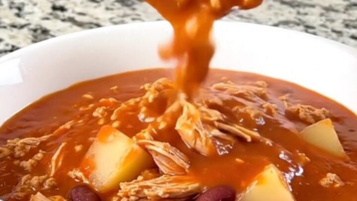 A rustic bowl of tomato-based shipwreck stew featuring ground turkey, beans, and potato cubes.