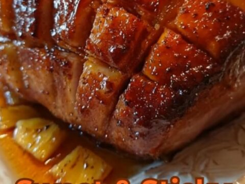 A beautifully roasted holiday ham with a glossy, caramelized diamond crust on a white serving platter