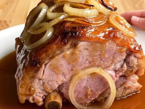 A whole boneless ham braised in a slow cooker with onions and a maple beer glaze.