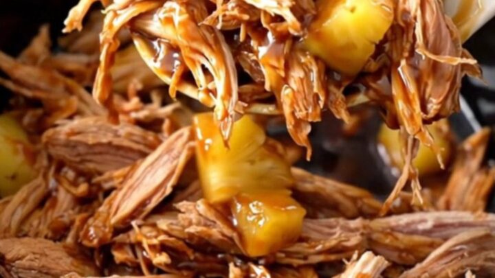 A bowl of shredded teriyaki pork with pineapple chunks and a glossy sauce.