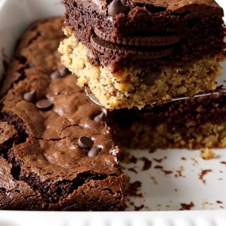 Triple layer cookie brownie bars showing distinct layers of cookie dough, sandwich cookies, and fudgy brownie.