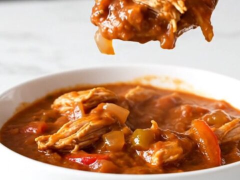 A bowl of hearty ground turkey and pepper chili in a slow cooker setting.