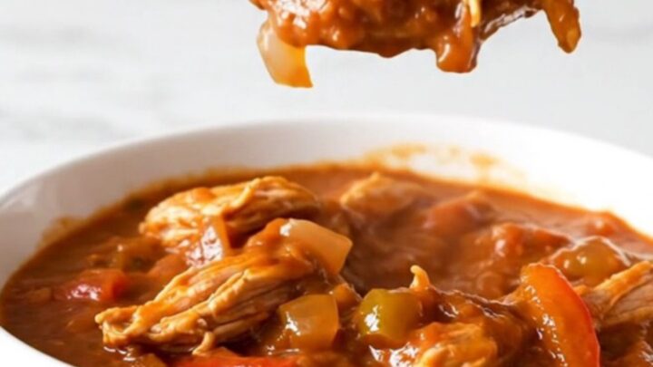 A bowl of hearty ground turkey and pepper chili in a slow cooker setting.