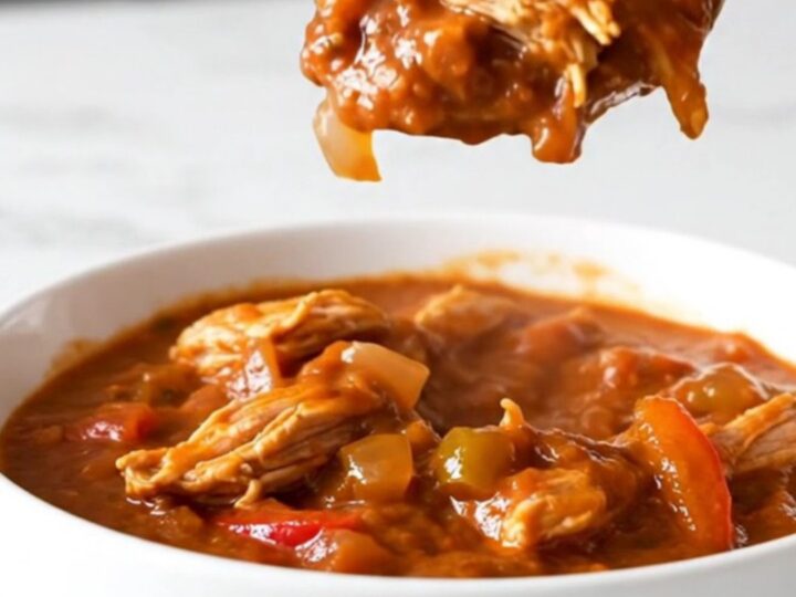 A bowl of hearty ground turkey and pepper chili in a slow cooker setting.