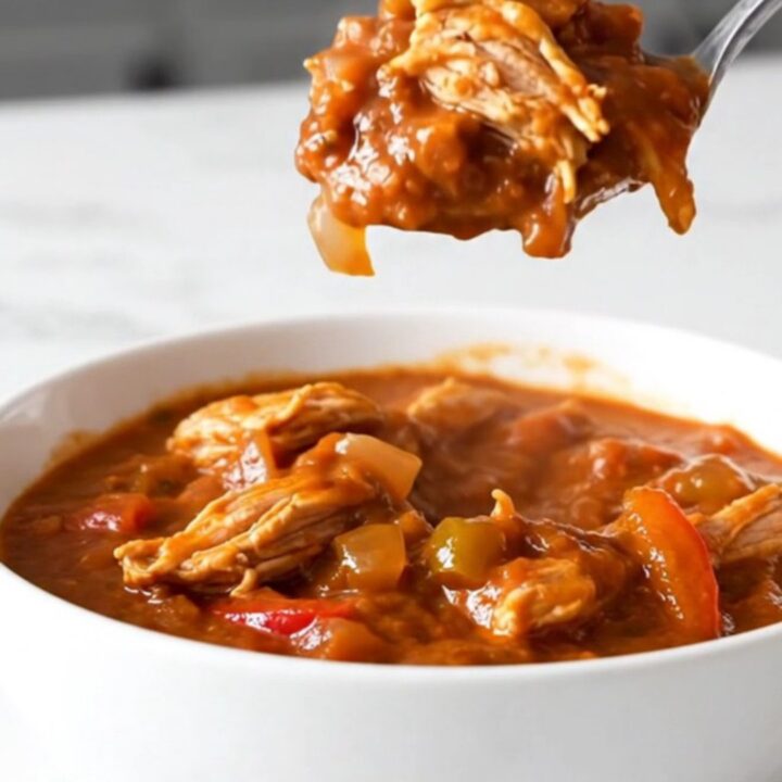 A bowl of hearty ground turkey and pepper chili in a slow cooker setting.