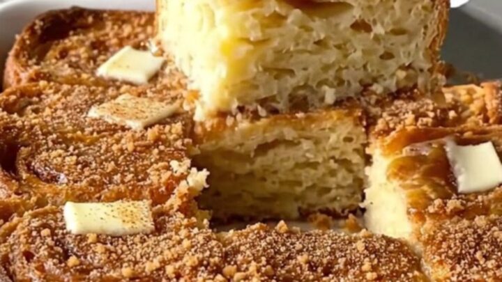 A golden, puffed French toast bake fresh from the oven in a rectangular ceramic dish.
